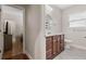 Well-lit bathroom featuring a vanity with wood cabinets, tile floor, and a decorative round mirror at 216 S Holly Ave, Sanford, FL 32771