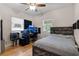 Comfortable bedroom with bamboo floors, ceiling fan and a desk area at 216 S Holly Ave, Sanford, FL 32771