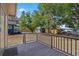 Backyard deck with wood railings and view of the landscaped yard with lush foliage and trees at 216 S Holly Ave, Sanford, FL 32771