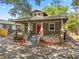 Cozy bungalow with a red door, inviting front porch, and well-maintained landscaping at 216 S Holly Ave, Sanford, FL 32771