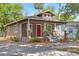 Charming bungalow-style home features a red front door and a welcoming front porch at 216 S Holly Ave, Sanford, FL 32771