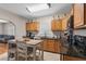 Bright kitchen with wood cabinets, dark countertops, and a view to the cozy living space at 216 S Holly Ave, Sanford, FL 32771