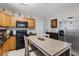 Eat-in kitchen with wood cabinets, granite counters and stainless steel appliances, perfect for casual dining at 216 S Holly Ave, Sanford, FL 32771