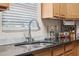 Close-up of a stainless steel kitchen sink with modern faucet fixture and granite countertops at 216 S Holly Ave, Sanford, FL 32771