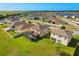 An aerial view of the backyard features a screened-in patio and a spacious lawn at 2211 Wadeview Loop, St Cloud, FL 34769