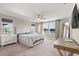 Bright bedroom with large windows, a view, and a cozy bed, creating a serene retreat at 2211 Wadeview Loop, St Cloud, FL 34769