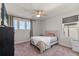 Comfortable bedroom features three large windows, a ceiling fan, and neutral colored carpet at 2211 Wadeview Loop, St Cloud, FL 34769