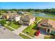 Beautiful two-story home with a well-manicured lawn and a view of a lake with a fountain at 2211 Wadeview Loop, St Cloud, FL 34769