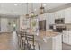 Bright kitchen with granite island, bar stool seating, stainless appliances, and pendant lighting at 2211 Wadeview Loop, St Cloud, FL 34769