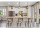Inviting kitchen island with bar stool seating, stainless appliances, and modern pendant lighting at 2211 Wadeview Loop, St Cloud, FL 34769