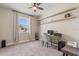 Bright office space with shelving, a ceiling fan, a large window, and neutral colored carpet at 2211 Wadeview Loop, St Cloud, FL 34769