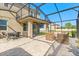 Relax in style in the screened-in patio featuring brick pavers and comfortable seating at 2211 Wadeview Loop, St Cloud, FL 34769