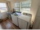 Functional laundry room with modern washer, dryer, and water heater setup at 232 S Clara Ave, Deland, FL 32720