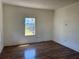 Bright living room featuring wood-look floors and a large window with a view to the yard at 232 S Clara Ave, Deland, FL 32720