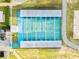Aerial view of shuffleboard court with covered seating, surrounded by lush landscape at 236 Marion Oaks Mnr, Ocala, FL 34473