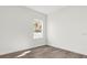 Bright, empty bedroom with luxury vinyl plank floors and a window at 236 Marion Oaks Mnr, Ocala, FL 34473