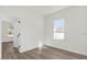 Bedroom with luxury vinyl plank floors and a window overlooking a backyard at 236 Marion Oaks Mnr, Ocala, FL 34473