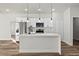 Spacious kitchen featuring stainless steel appliances, white cabinets, and island with pendant lights at 236 Marion Oaks Mnr, Ocala, FL 34473