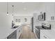 Modern kitchen with stainless steel appliances, white cabinets, and wood-look flooring at 236 Marion Oaks Mnr, Ocala, FL 34473
