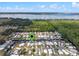 Aerial shot of homes with boat docks along canals, near a lake, under a sunny sky. Green pin shows location at 25931 Azalea Ln, Astatula, FL 34705