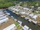 Aerial view of homes in a waterfront community connected by canals and docks at 25931 Azalea Ln, Astatula, FL 34705
