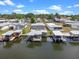 Aerial view features waterfront homes with boat docks on canals in a friendly neighborhood at 25931 Azalea Ln, Astatula, FL 34705