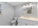 Bright bathroom with a white vanity, countertop, and framed mirror above the sink at 25931 Azalea Ln, Astatula, FL 34705