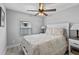 Comfortable bedroom with a white quilt and a window at 25931 Azalea Ln, Astatula, FL 34705
