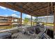 Covered boat dock featuring a boat lift and wooden deck overlooking the water at 25931 Azalea Ln, Astatula, FL 34705