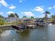 Modern boat dock with lifts offers easy water access, perfect for boating enthusiasts at 25931 Azalea Ln, Astatula, FL 34705