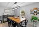 Dining room features a wood table with black metal chairs, modern light fixture and many decorations at 25931 Azalea Ln, Astatula, FL 34705