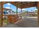 Covered dock with swing and dining area overlooking the waterfront at 25931 Azalea Ln, Astatula, FL 34705