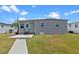 Charming single-story home with a delightful blue front door and freshly cut lawn at 25931 Azalea Ln, Astatula, FL 34705
