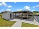 Waterfront home with a covered boat dock offering a boat slip and swing for relaxing by the canal at 25931 Azalea Ln, Astatula, FL 34705