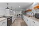 Contemporary kitchen featuring granite counters and wood-look floors at 25931 Azalea Ln, Astatula, FL 34705
