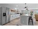 Bright kitchen with an island bar and stainless steel refrigerator at 25931 Azalea Ln, Astatula, FL 34705