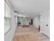 Bright living room with recessed lights, wood-look floors, and a light blue entry door at 25931 Azalea Ln, Astatula, FL 34705