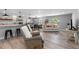 An open living space with modern design, including a bar, dining area, and seating area at 25931 Azalea Ln, Astatula, FL 34705