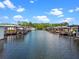 Picturesque waterfront showing multiple covered boat docks, providing easy boat access at 25931 Azalea Ln, Astatula, FL 34705