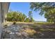 Expansive backyard features mature trees and shrubs with lake views at 2613 Howland Blvd, Deltona, FL 32738