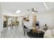 Spacious open-concept living and dining area with modern decor, tile flooring, and abundant natural light at 2613 Howland Blvd, Deltona, FL 32738