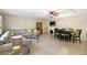 Open living room boasts tile floors, a fireplace, and a dining area for easy entertaining at 2613 Howland Blvd, Deltona, FL 32738