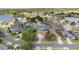 Overhead view showcasing the neighborhood with mature trees, green lawns, and nearby lake at 2837 Drifting Lilly Loop, Kissimmee, FL 34747