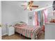 Bedroom with striped bedding, side tables, and pastel colored curtains over the windows at 2837 Drifting Lilly Loop, Kissimmee, FL 34747