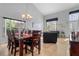 Inviting dining area with a wooden table set, large windows, and neutral paint at 2837 Drifting Lilly Loop, Kissimmee, FL 34747