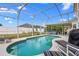 A private screened-in pool with lounge chairs and outdoor dining area for relaxation at 2837 Drifting Lilly Loop, Kissimmee, FL 34747