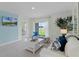 Cozy living room with a sliding glass door, comfortable seating, and a mounted TV for relaxing evenings at 2876 House Finch Rd, St Cloud, FL 34773