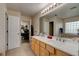 Bathroom with double sinks, ample countertop space, and a view to an office in the background at 2951 E Waco Dr, Deltona, FL 32738