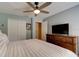 Bright bedroom with a ceiling fan, large window, and dark wood dresser for ample storage at 2951 E Waco Dr, Deltona, FL 32738
