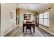 Cozy dining area with wood floors, chandelier, and a large window at 2951 E Waco Dr, Deltona, FL 32738